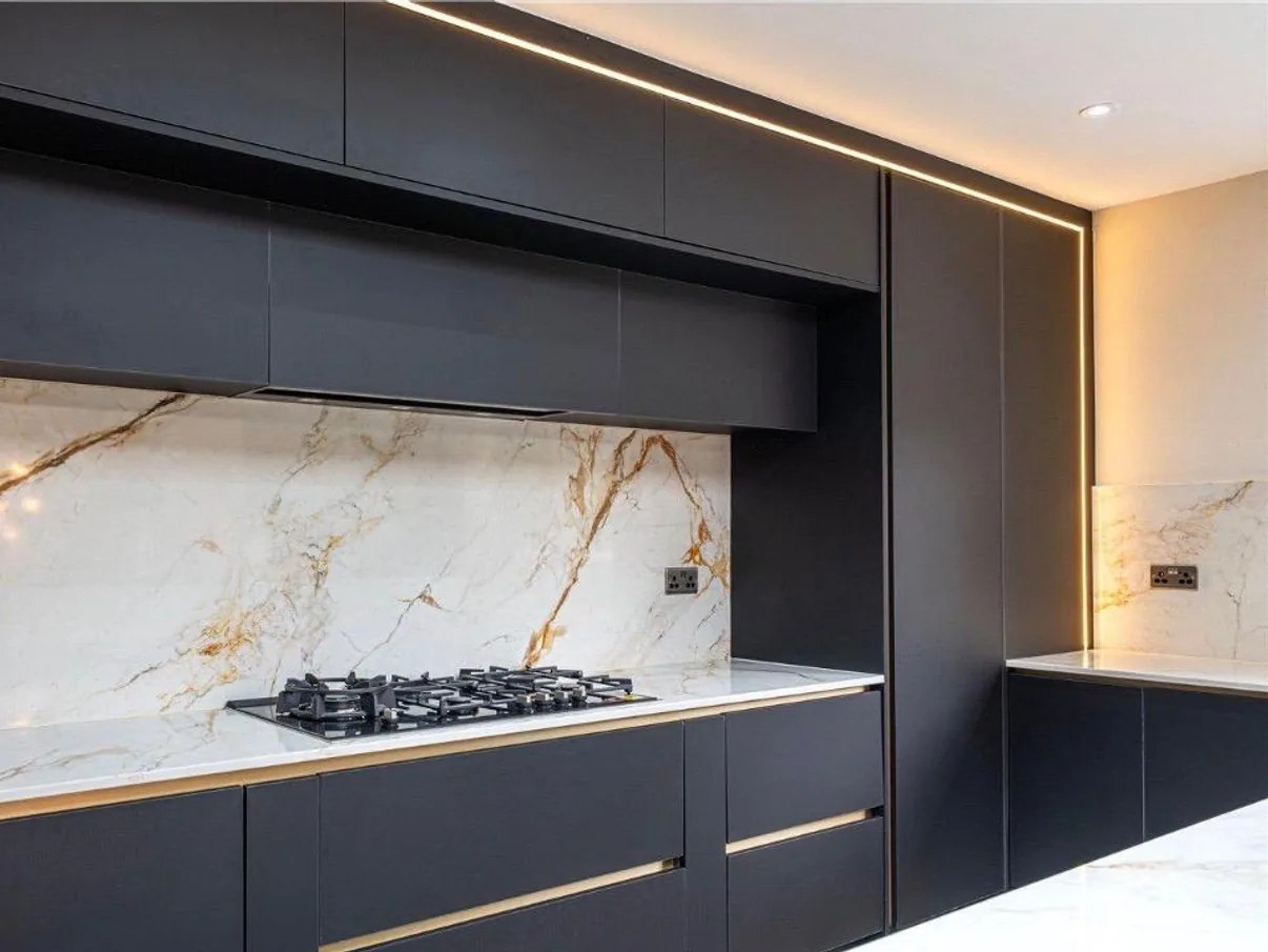 A bespoke fitted kitchen with an island and quartz worktop
