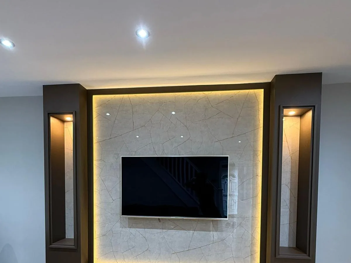 A bespoke media wall in fluted oak with an inset fire